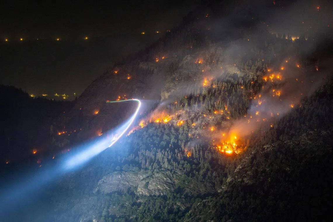 General view of a wildfire on the flank of a mountain in Bitsch near Brig, Switzerland, July 18, 2023. Picture taken with a long exposure. REUTERS/Denis Balibouse     TPX IMAGES OF THE DAY     