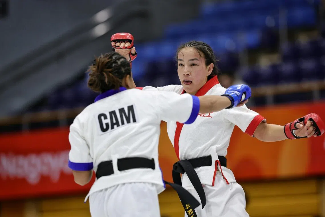 Khilola Sobirova of Uzbekistan prancing around Cheng Dalin of Cambodia during the mixed martial arts women’s traditional (60kg) semifinal in Japan.