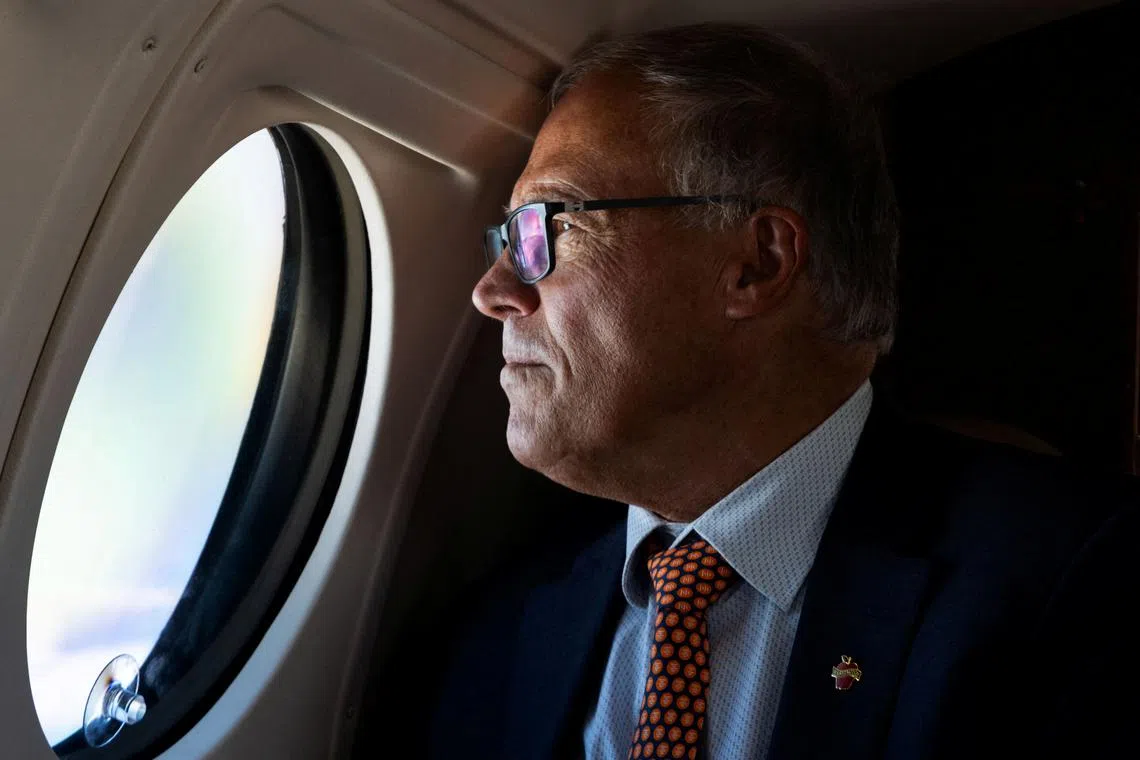 FILE PHOTO: Washington Governor Jay Inslee looks out the window of a Washington State Patrol plane while traveling across the state, U.S., September 18, 2024. REUTERS/Matt Mills McKnight/File Photo