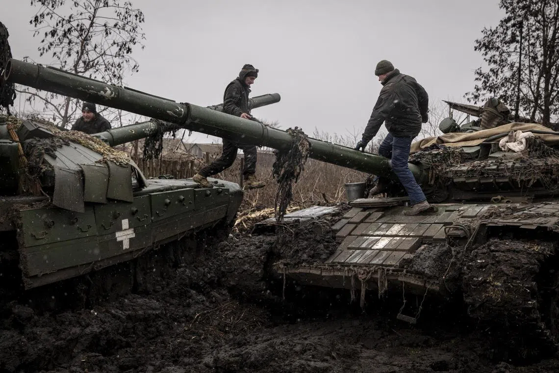 Ukrainian servicemen work to salvage equipment and parts from a broken T-72 tank, in the Donetsk region of Ukraine, on Jan 5, 2023.