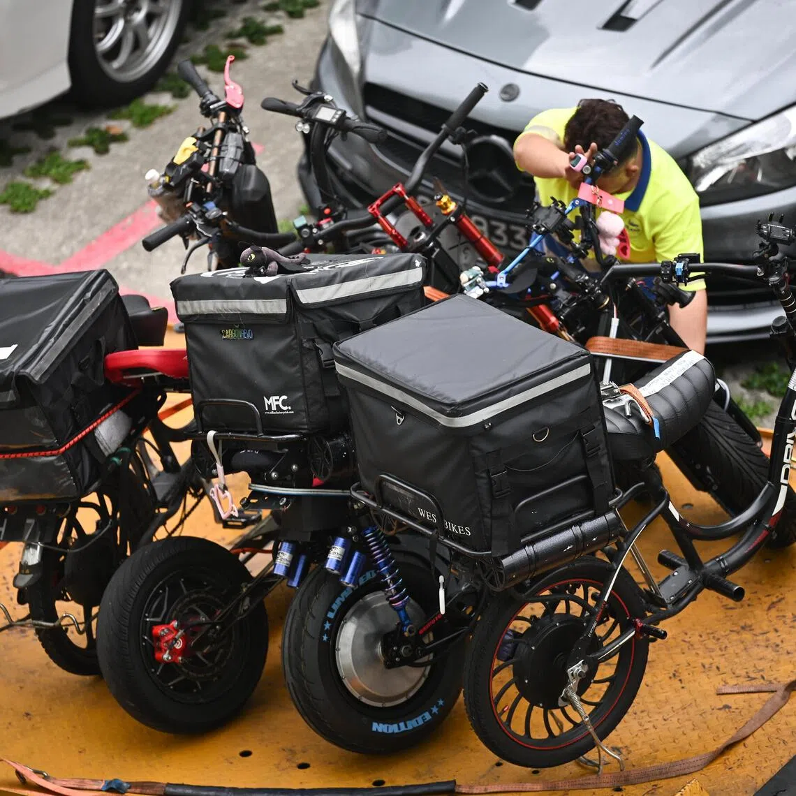 Non-compliant active mobility devices confiscated by LTA being loaded onto a tow truck in Yishun on Nov 20.