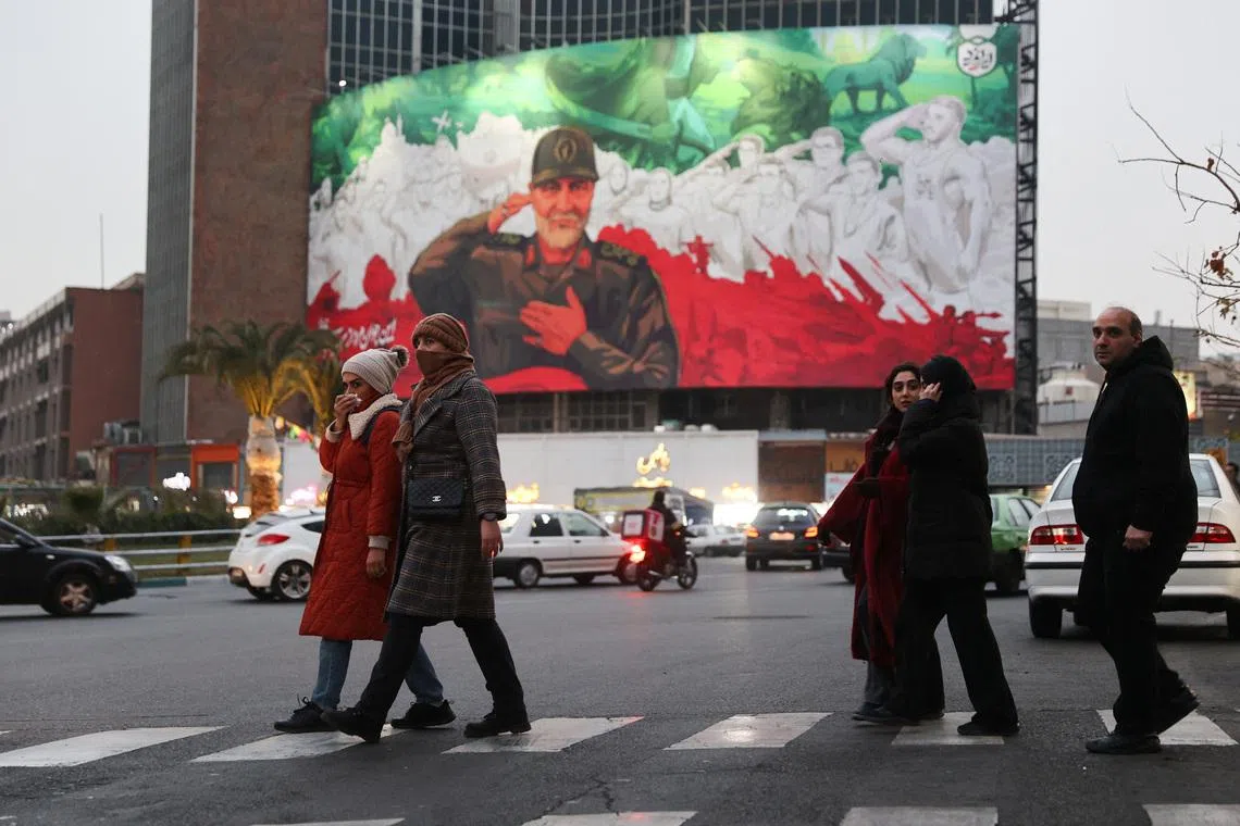 People walk on a street as protests erupt over the collapse of the currency's value in Tehran, Iran, January 2, 2026. Majid Asgaripour/WANA (West Asia News Agency) via REUTERS