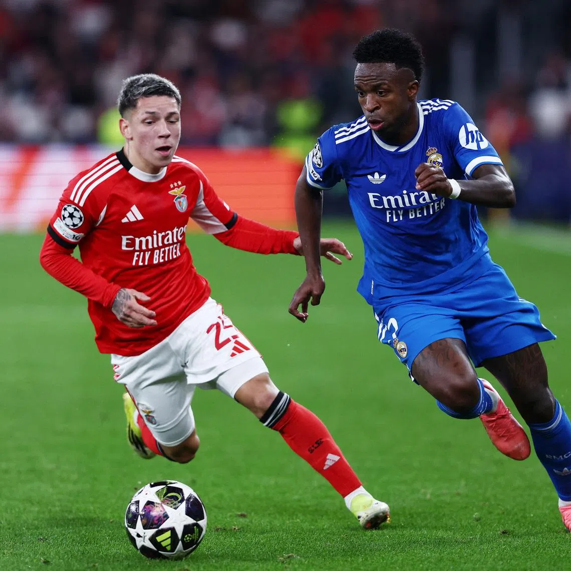 Soccer Football - UEFA Champions League - Play Off - First Leg - Benfica v Real Madrid - Estadio da Luz, Lisbon, Portugal - February 17, 2026 Benfica's Gianluca Prestianni in action with Real Madrid's Vinicius Junior REUTERS/Rodrigo Antunes
