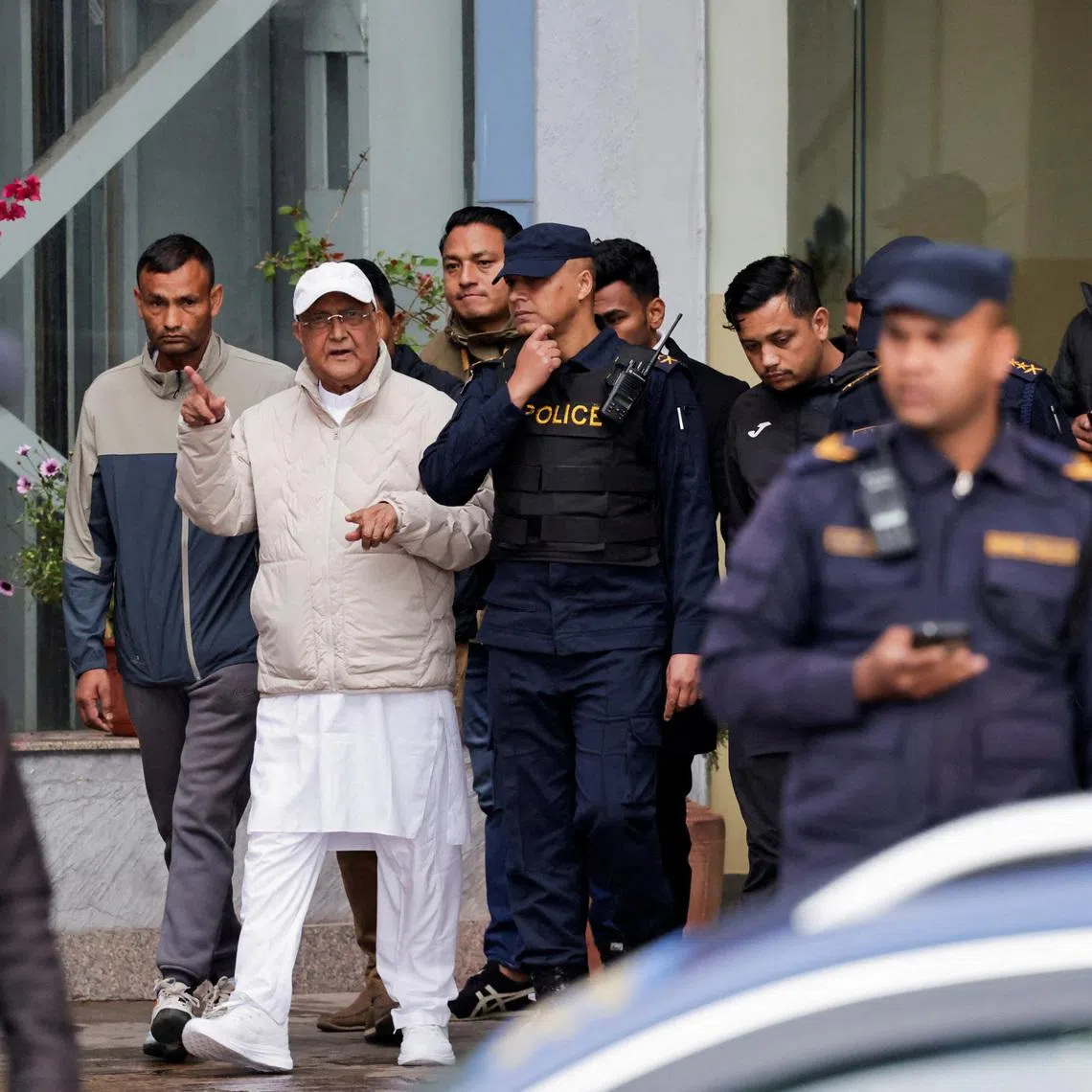 Nepal’s former prime minister K.P. Sharma Oli (front, centre) being taken to a hospital after his detention by the police in Kathmandu on March 28.