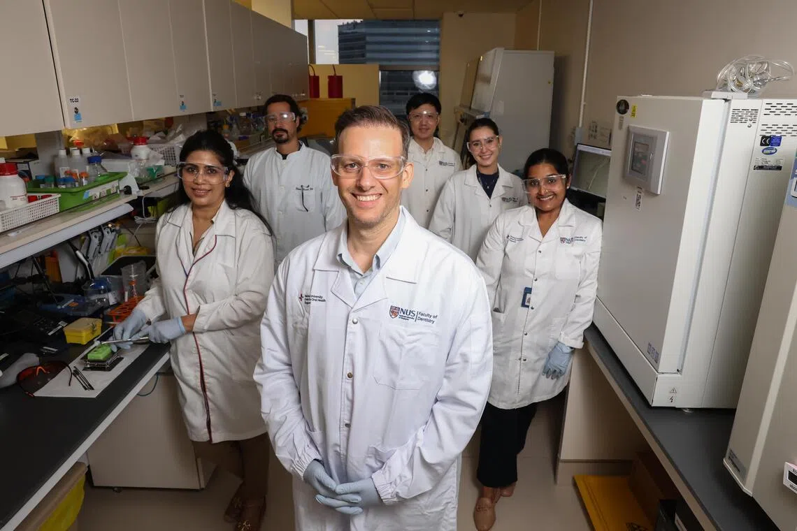 Associate Professor Vinicius Rosa (centre) with his research team in their lab at the National University Centre for Oral Health Singapore on April 30.