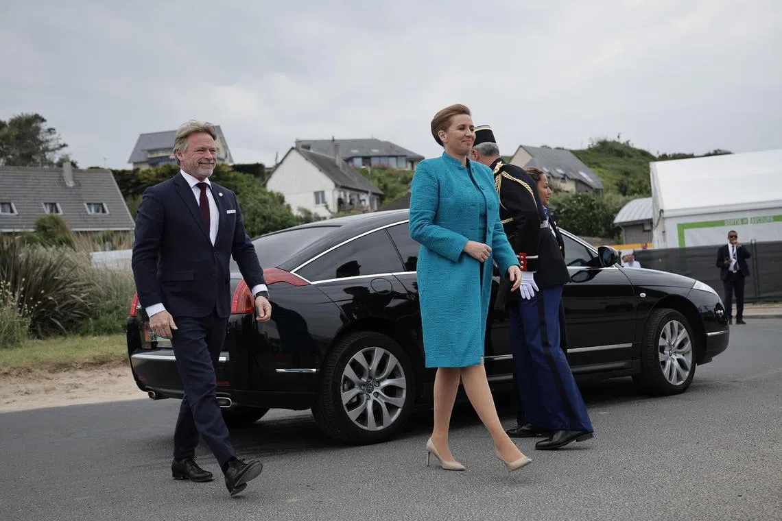 Denmark's Prime Minister Mette Frederiksen (centre) and her husband Bo Tengberg (left) attending a commemorative ceremony for the 80th anniversary of the World War II D-Day landings, in Normandy, France, on June 6.