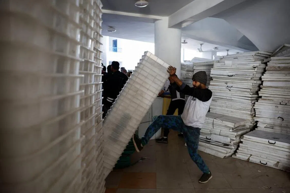 A man unloads ballot boxes to dispatch them to a polling station, a day ahead of the general election, in Lahore, Pakistan February 7, 2024. REUTERS/Navesh Chitrakar