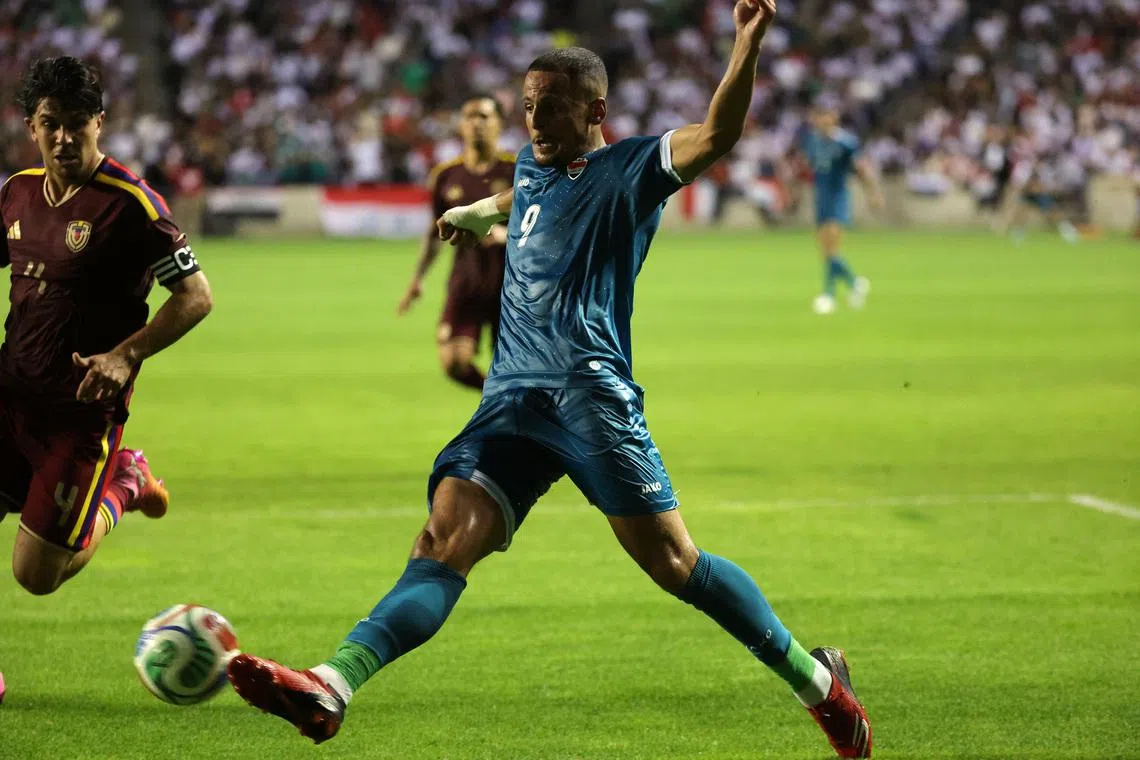 Jun 9, 2026; Bridgeview, Illinois, USA; Iraq forward Ali al-Hamadi (9) kicks the ball against Venezuela during the first half at SeatGeek Stadium. Mandatory Credit: Mike Dinovo-Imagn Images