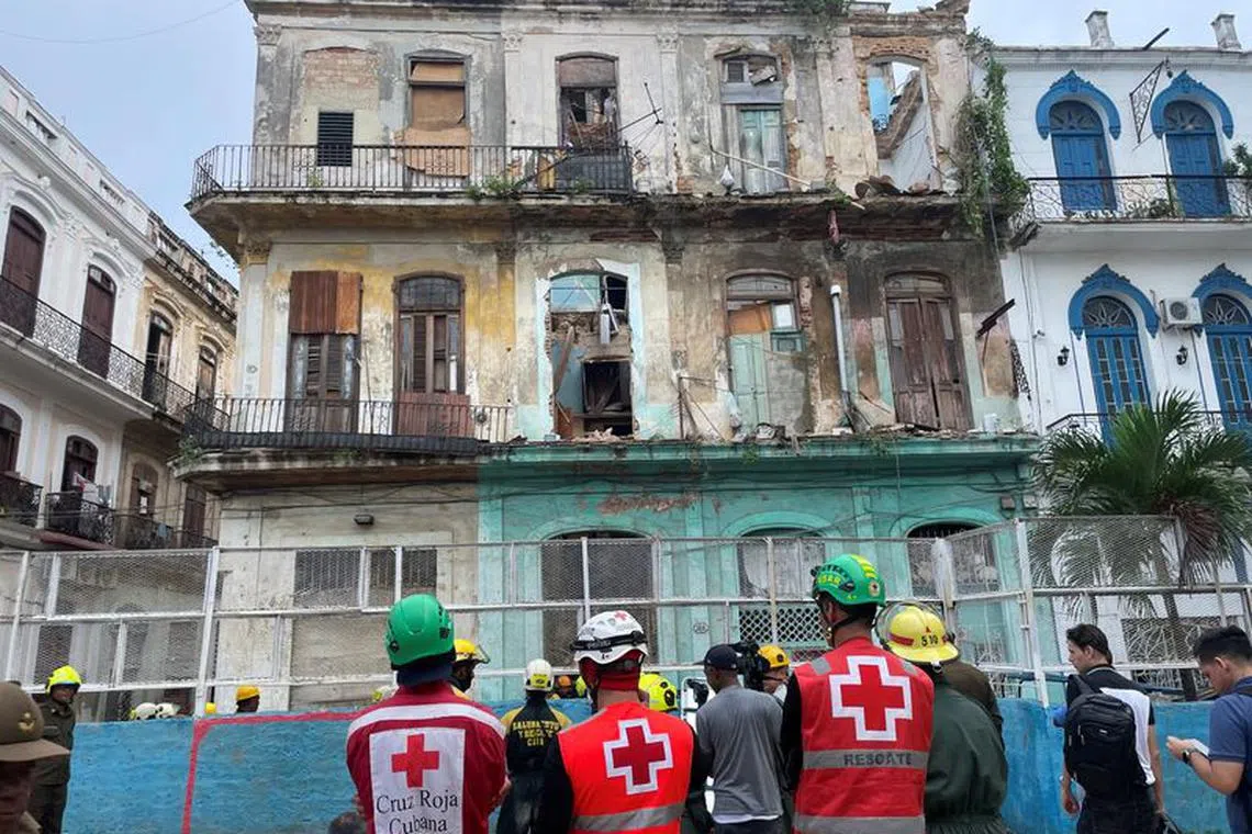 Emergency services work on the site where a residencial building collapsed in Havana, Cuba, October 4, 2023. REUTERS/Alexandre Meneghini
