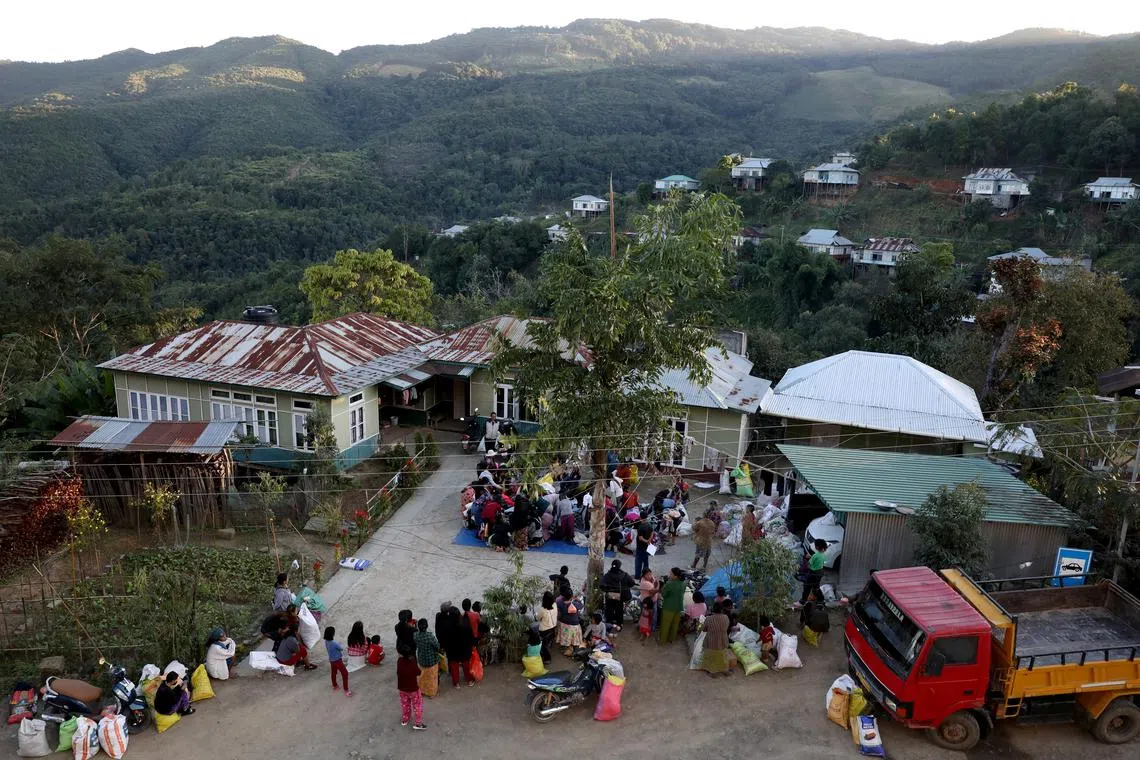 FILE PHOTO: People who fled from Myanmar collect donated clothes at a temporary distribution centre at Farkawn village near the India-Myanmar border, in the northeastern state of Mizoram, India, November 20, 2021. Picture taken November 20, 2021. REUTERS/Rupak De Chowdhuri/File Photo