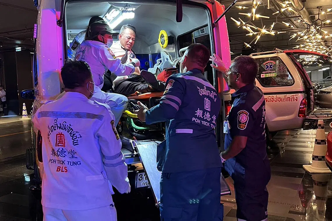 A handout photo made available by the Rescue Foundation of Bangkok showing a man injured in a shooting at at the Siam Paragon shopping mall being loaded onto an ambulance by the Rescue Foundation, in Bangkok, Thailand, October 3, 2023. 