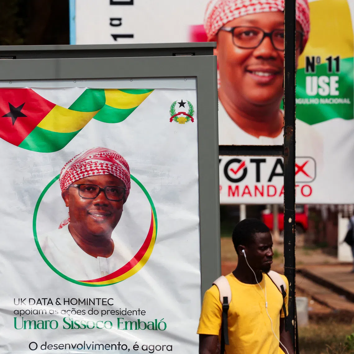 A man stands near campaign billboards of Guinea-Bissau's outgoing President Umaro Sissoco Embalo, ahead of the presidential election scheduled for November 23, in Bissau, Guinea-Bissau November 20, 2025. REUTERS/Luc Gnago