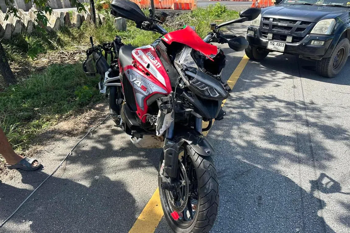 Mr Mohamed Reza Abdul Rashid's motorcycle after it had been retrieved from the grass patch where it laid. The 43-year-old Singaporean died on Monday morning in Phattalung province, Thailand.