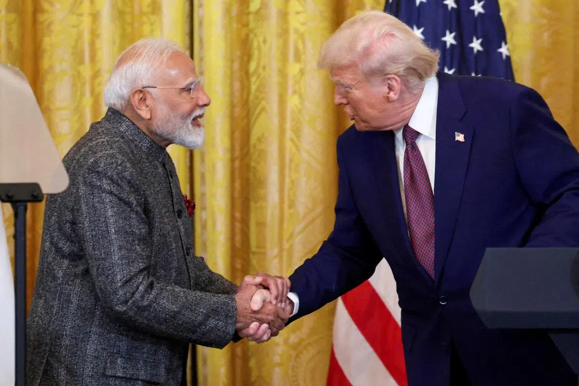 FILE PHOTO: U.S. President Donald Trump and Indian Prime Minister Narendra Modi shake hands as they attend a joint press conference at the White House in Washington, D.C., U.S., February 13, 2025. REUTERS/Kevin Lamarque/File Photo