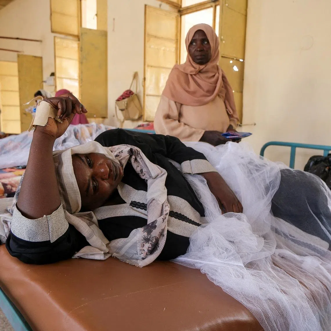 FILE PHOTO: Sudanese women lie in beds as they receive treatment for dengue fever at Omdurman Hospital, as Sudan grapples with outbreaks of dengue and cholera amid the annual rainy season and a collapsed healthcare and infrastructure system, in Khartoum, Sudan, September 23, 2025. REUTERS/El Tayeb Siddig/File Photo