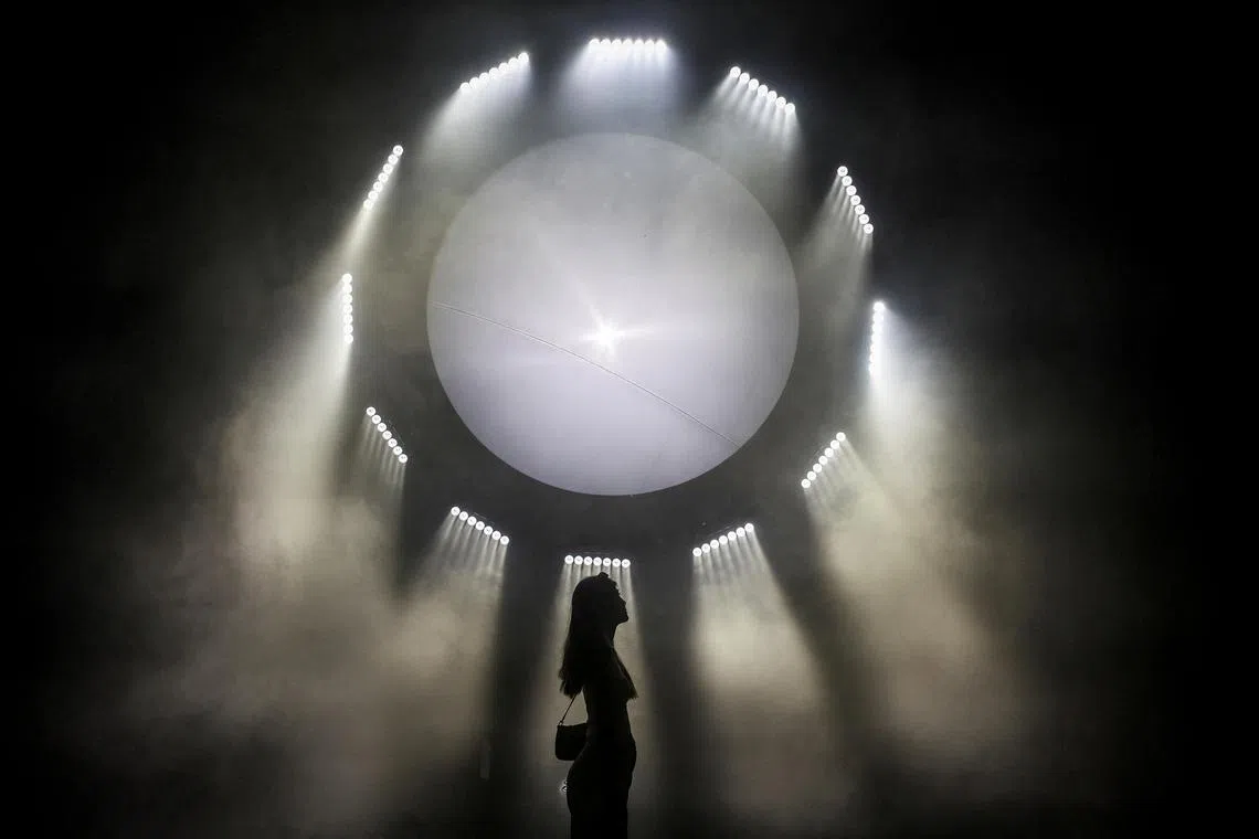 A woman attending "MOONLAB", an intergalactic art exhibition and installation, in Bangkok, Thailand, on Mar 16, 2025. 