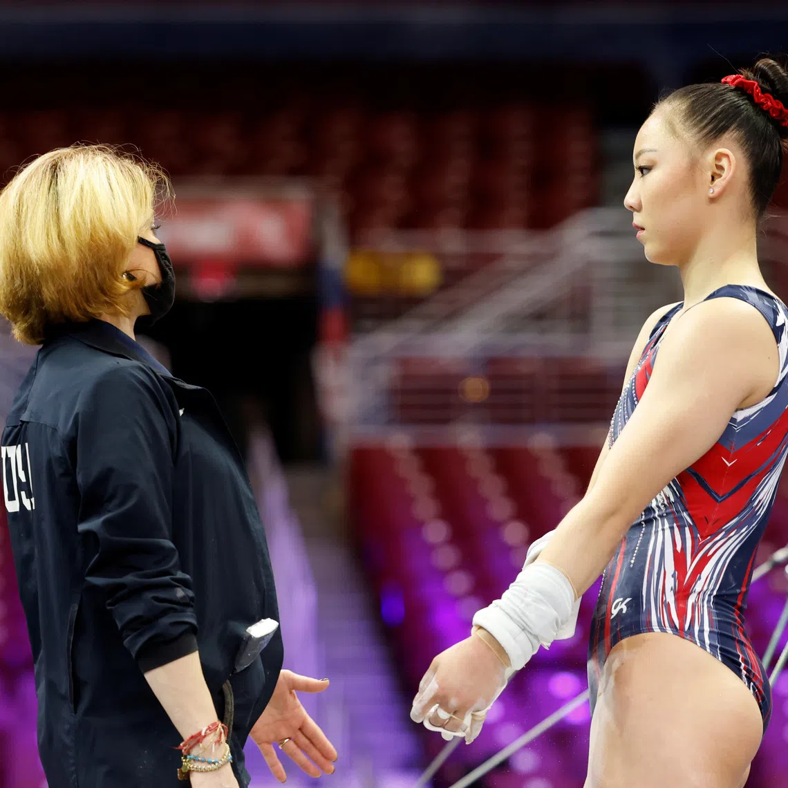 Kara Eaker talks to coach Armine Barutyan during a training day before the U.S. Olympic Team Trials for gymnastics in St. Louis, Missouri, U.S., June 23, 2021. REUTERS/Lindsey Wasson