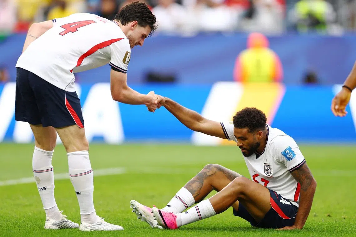 Soccer Football - FIFA World Cup 2026 - Group L - England v Ghana - Boston Stadium, Foxborough, Massachusetts, U.S. - June 23, 2026 England's Declan Rice helps Reece James REUTERS/Peter Cziborra