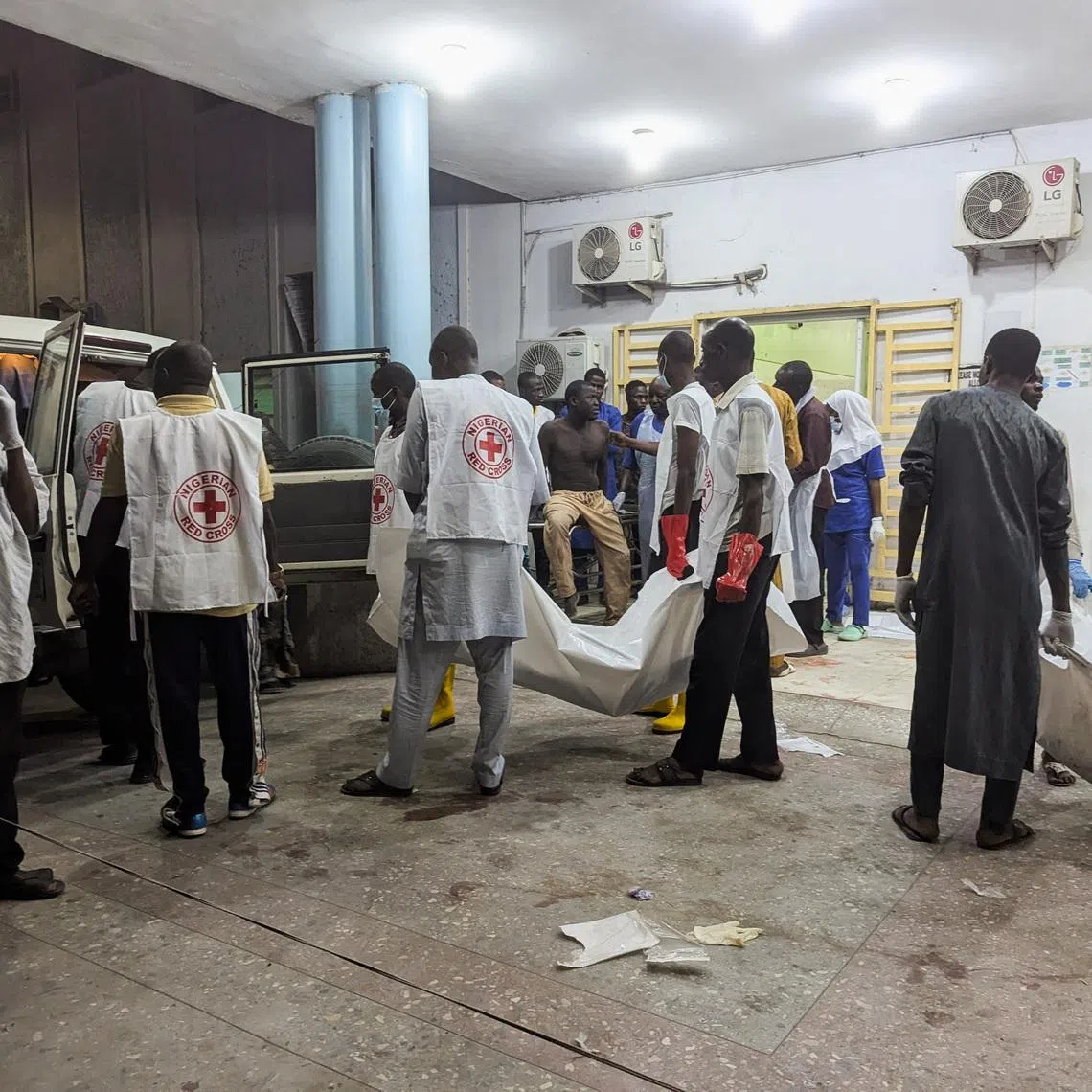 Members of the Nigerian Red Cross carry body bags containing casualties at a Maiduguri hospital following explosions that struck the northeastern city of Maiduguri, Borno State, Nigeria, March 16, 2026. REUTERS/Adewale Kolawole