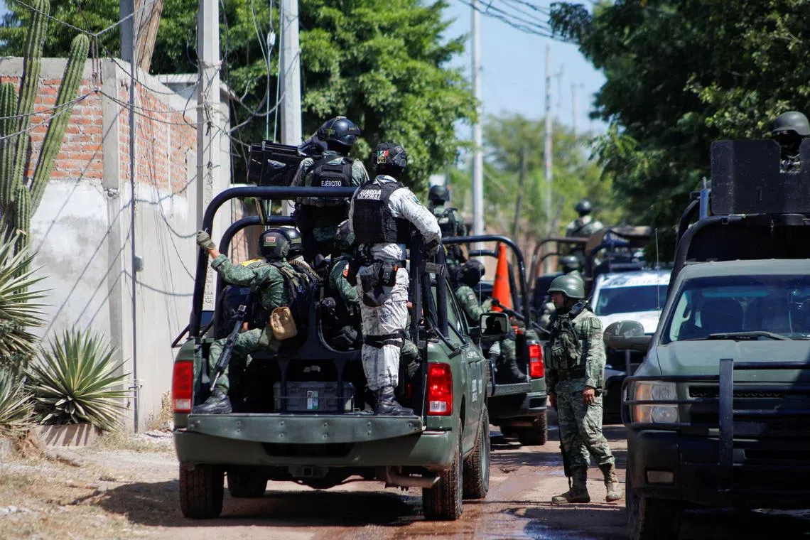 FILE PHOTO: Federal forces guard the perimeter of a scene following a shootout where several suspected gang members were killed while one local cartel leader was arrested, on the outskirts of Culiacan, Sinaloa state, Mexico October 22, 2024. REUTERS/Jose Betanzos/File Photo