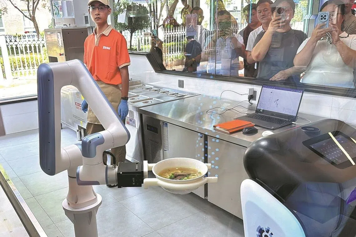 At this Beijing restaurant, robots make and cook your noodles, and deliver them to your table