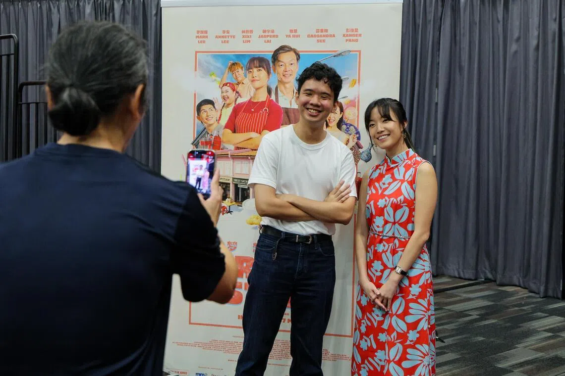The 29-year-old software engineer having a photo taken with actress-director Annette Lee after getting his refund.
