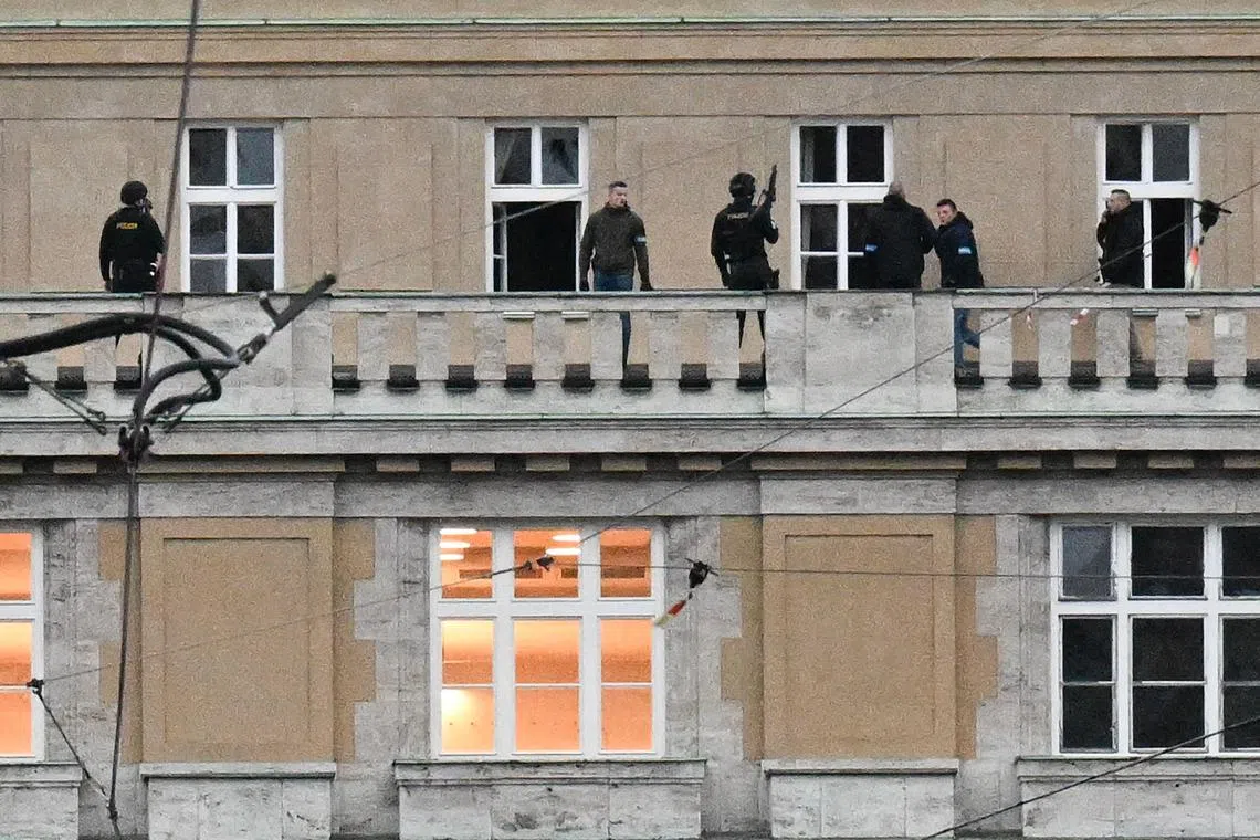 Armed police are seen on the balcony of a Charles University building in central Prague, where a student shot and killed 14 people.