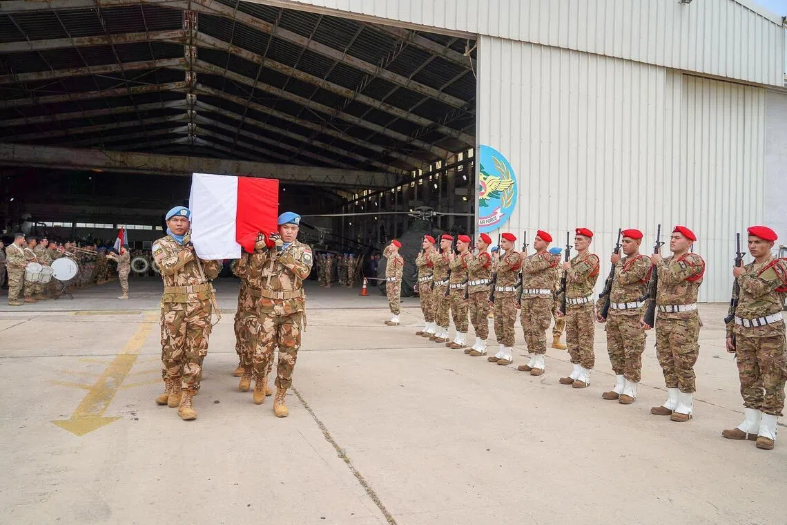 This handout photograph, taken and released by the United Nations Interim Force in Lebanon (UNIFIL), shows comrades carrying the coffin of 31-year-old Indonesian Corporal Rico Pramudia as he is honoured during a ceremony held at the International Airport in the Lebanese capital Beirut on April 26, 2026. The UN peacekeeping force in Lebanon, UNIFIL, announced on April 24, 2026, that an Indonesian blue helmet died in hospital of wounds suffered on March 29 in an attack on his base. "UNIFIL deplores the passing today of Corporal Rico Pramudia, who was critically injured following a projectile explosion in his base in Adchit Al Qusayr on the night of 29 March," the force said in a statement. His death brings to six the number of peacekeepers killed since the start of the most recent war between Israel and Hezbollah on March 2. (Photo by Haidar Fahs / UNIFIL / AFP) / RESTRICTED TO EDITORIAL USE - MANDATORY CREDIT "AFP PHOTO / UNIFIL /HANDOUT / Haidar Fahs" - HANDOUT - NO MARKETING NO ADVERTISING CAMPAIGNS - DISTRIBUTED AS A SERVICE TO CLIENTS