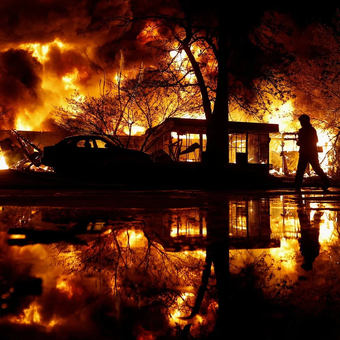 A firefighter works at the site of recycling materials hit by a Russian missile strike, amid Russia's attack on Ukraine, in Kyiv, Ukraine, April 16, 2026. REUTERS/Valentyn Ogirenko TPX IMAGES OF THE DAY