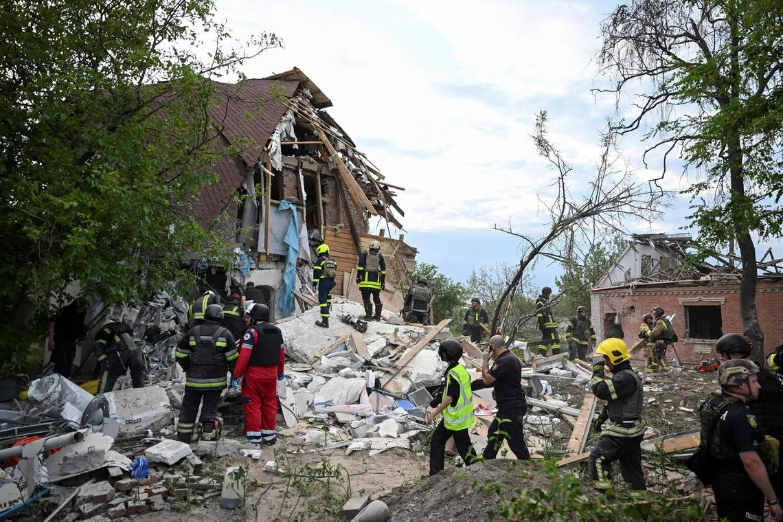 Rescuers work at a site of a private house destroyed during a Russian air strike, amid Russia's attack on Ukraine, in Kharkiv, Ukraine June 10, 2024. REUTERS/Viacheslav Ratynskyi/ File Photo