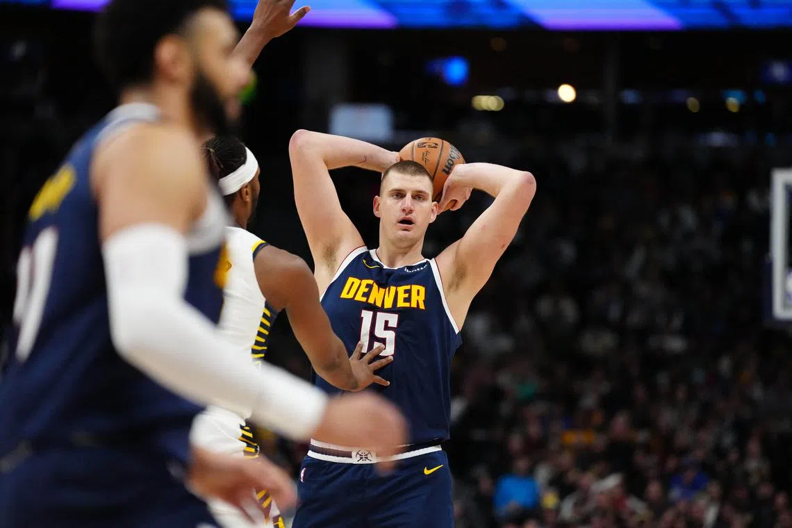 Denver Nuggets centre Nikola Jokic (No. 15) looking to pass in the second quarter against the Indiana Pacers at Ball Arena.
