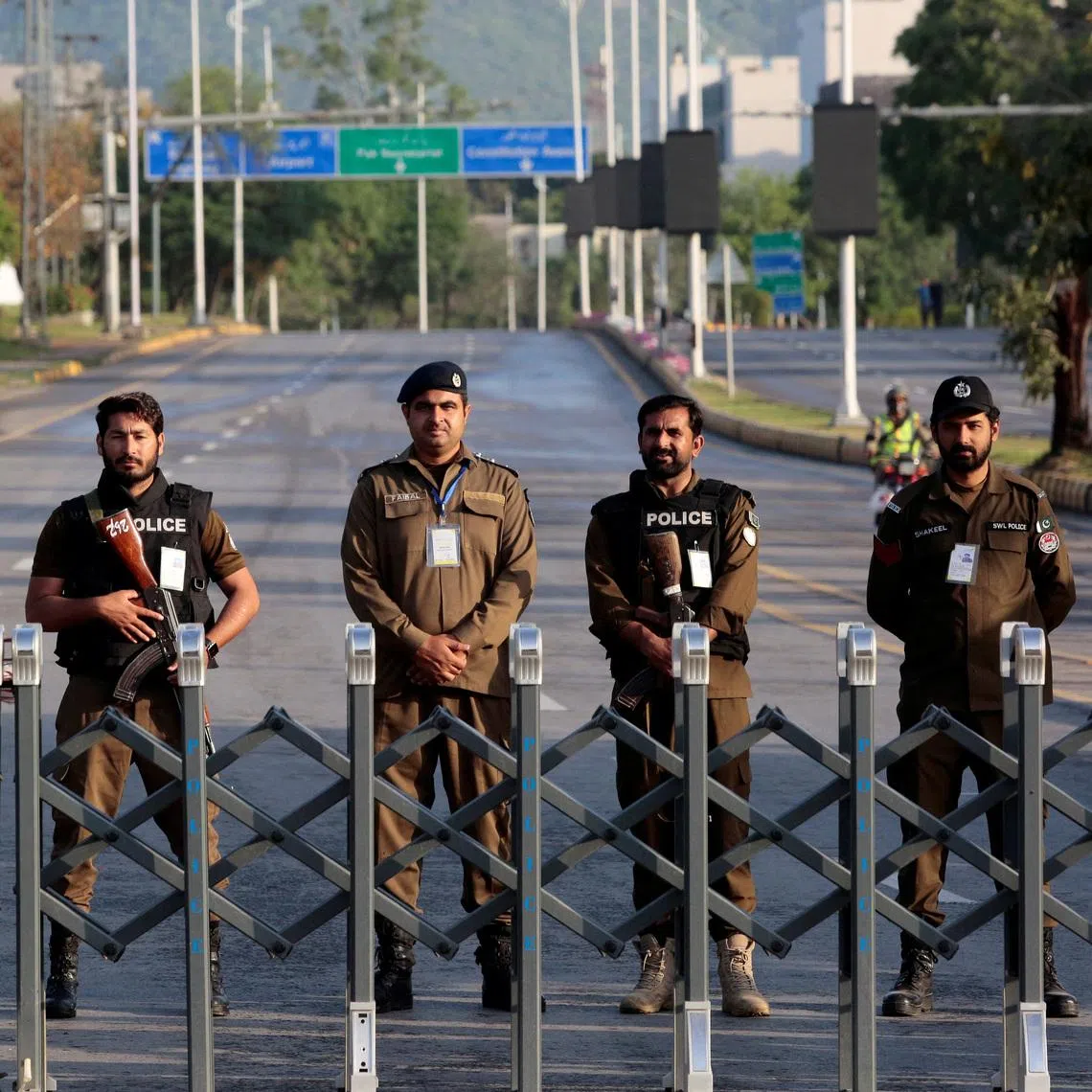 Police officers stand guard behind a barricade near Serena Hotel, as Pakistan prepares to host the U.S. and Iran for the second round of peace talks, in Islamabad, Pakistan, April 25, 2026.
