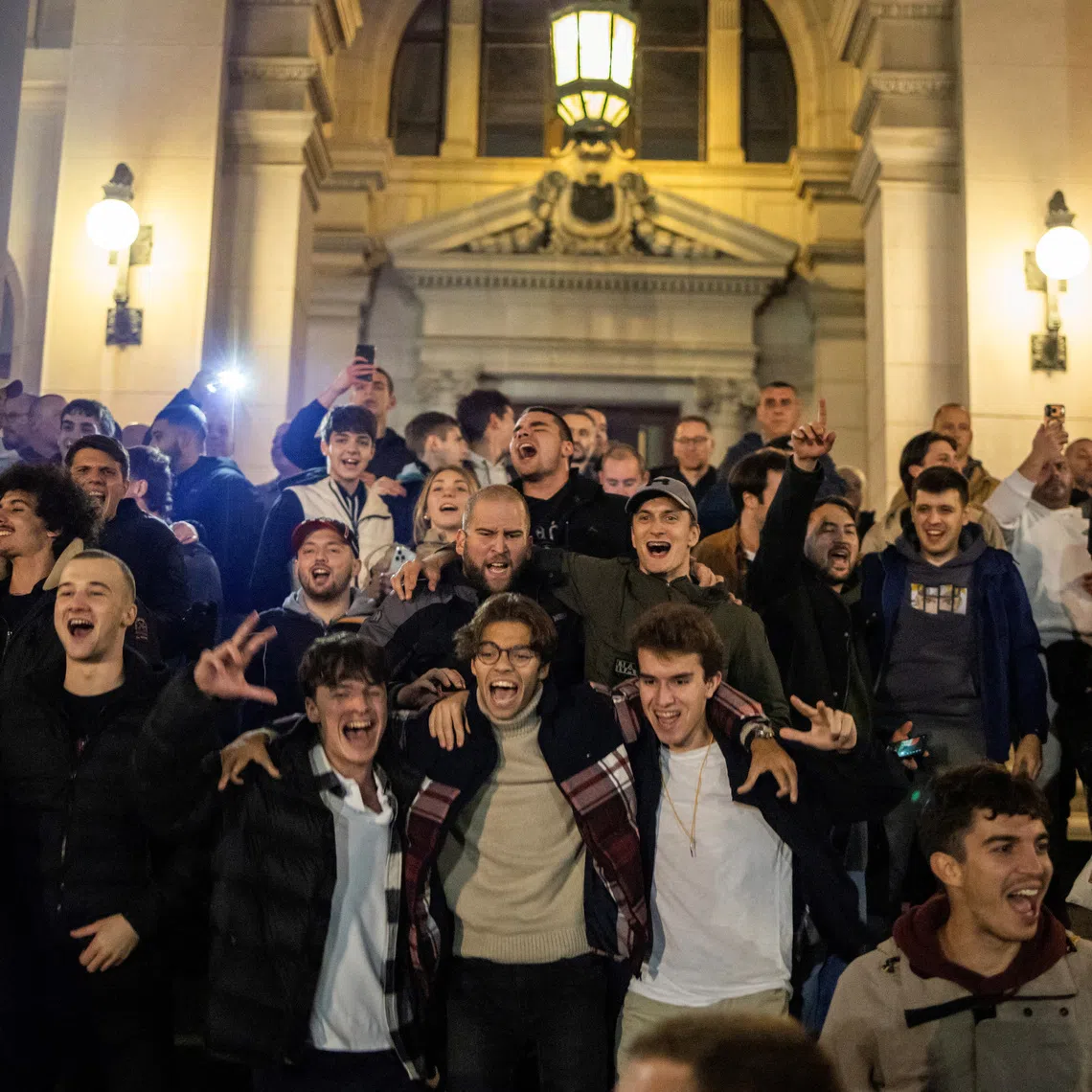 Supporters of the electoral list \"Student List - Students Win\" celebrate at the Parliament building after Aleksandar Vucic, Serbian Progressive Party (SNS) prime ministerial candidate, conceded defeat in the parliamentary election in Belgrade, Serbia, October 25, 2026. REUTERS/Marko Djurica