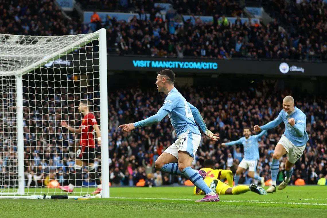 Soccer Football - Premier League - Manchester City v Manchester United - Etihad Stadium, Manchester, Britain - March 3, 2024 Manchester City's Phil Foden celebrates scoring their second goal with Erling Braut Haaland REUTERS/Carl Recine