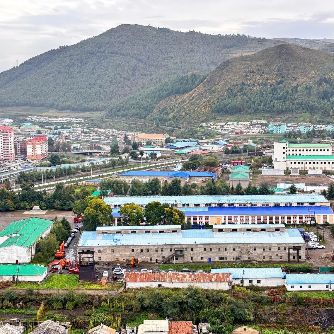 Cars are parked around buildings along the North Korean border in the city of Hyesan, North Korea, on Sept 28, 2025.