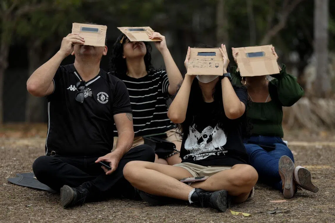 People watching the annular solar eclipse in Manaus, Amazonas state, Brazil, on Oct 14, 2023. 