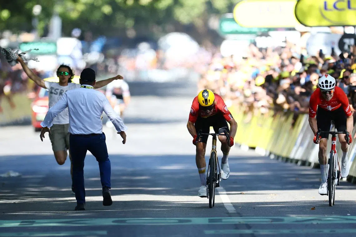 Cycling - Tour de France - Stage 11 - Toulouse to Toulouse - Toulouse, France - July 16, 2025 A protester runs onto the road near the finish line as Uno-X Mobility's Jonas Abrahamsen is seen in action on his way to winning stage 11 REUTERS/Sarah Meyssonnier