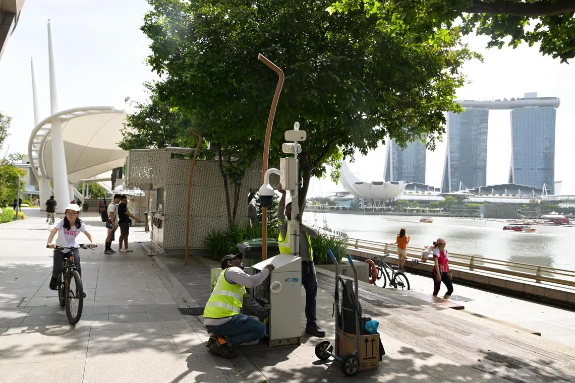 Workers setting up police security camera outside Esplanade on Dec 26, 2022. The Police are expecting large crowds to join in the festivities around Marina Bay.