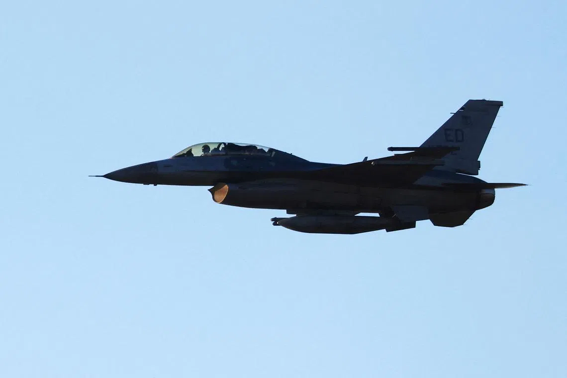 FILE PHOTO: An F-16 escorts the first flight of the United States Air Force's B-21 \"Raider\", in Palmdale, California, U.S., November 10, 2023. REUTERS/David Swanson/File Photo