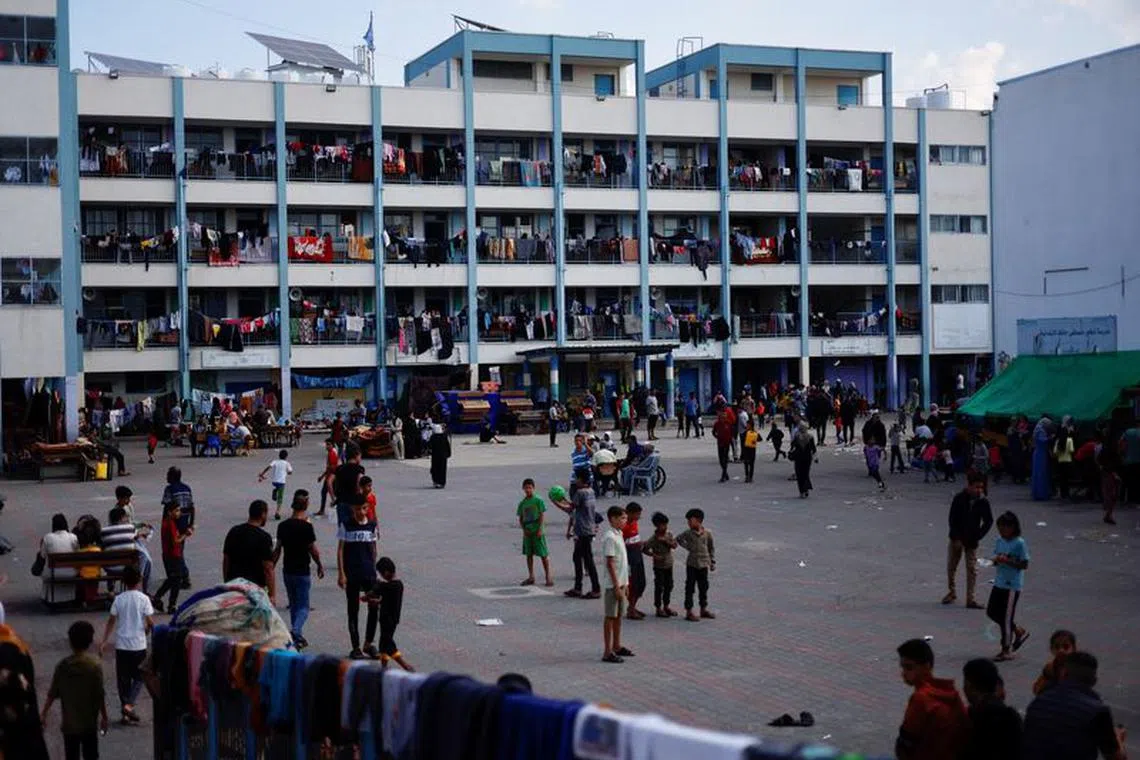 Palestinians, who fled their houses amid Israeli strikes, shelter at a United Nations-run school, after Israel's call for more than 1 million civilians in northern Gaza to move south, in Khan Younis in the southern Gaza Strip, October 16, 2023. REUTERS/Mohammed Salem