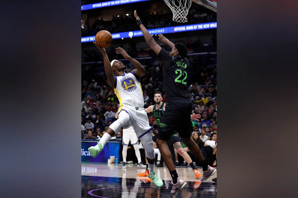 Jimmy Butler of the Golden State Warriors shoots over Derik Queen of the New Orleans Pelicans during the third quarter at Smoothie King Centre.