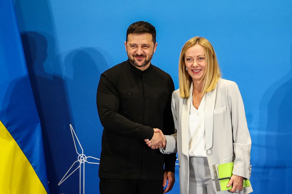 Italian Prime Minister Giorgia Meloni and Ukrainian President Volodymyr Zelenskiy shake hands as they attend a press conference on the first day of the two-day Ukraine Recovery Conference (URC2025), on plans for the reconstruction of Ukraine, in Rome, Italy, July 10, 2025. REUTERS/Guglielmo Mangiapane