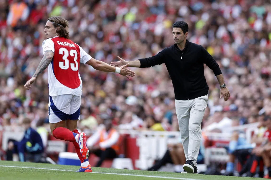 Arsenal's Riccardo Calafiori with manager Mikel Arteta during a pre-season friendly against Lyon.