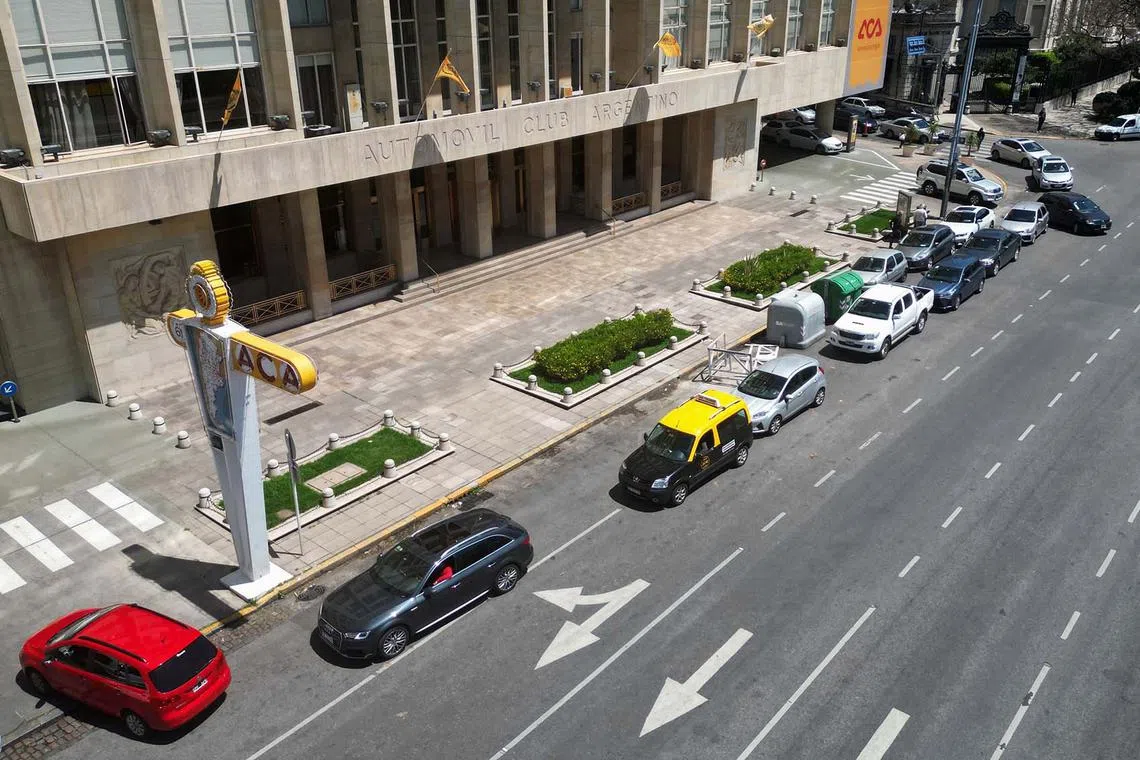 Drivers queue to fill the tanks of their cars at a gas station in Buenos Aires, on Oct 30, 2023. Long lines of cars to load fuel and gas stations with "sold out" signs have been part of the landscape for several days in Argentina.
