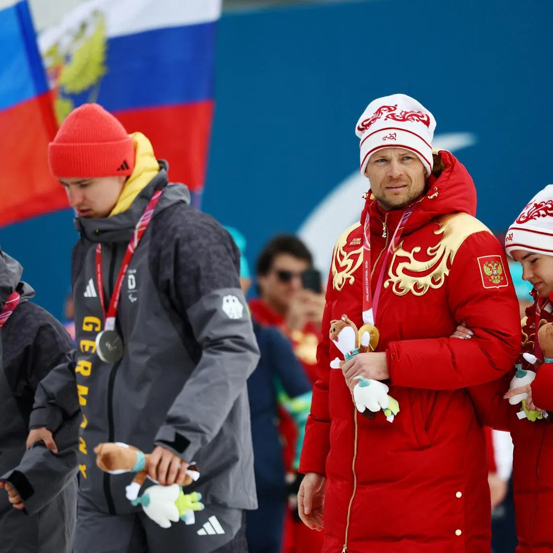Milano Cortina 2026 Paralympics - Para Cross-Country Skiing - Women's Sprint Classic Vision Impaired Victory Ceremony - Tesero Cross-Country Skiing Stadium, Lago, Italy - March 10, 2026. Gold medallists Anastasiia Bagiian of Russia and guide Sergei Siniakin of Russia and silver medallists Linn Kazmaier of Germany and guide Florian Baumann of Germany exit the podium after the victory ceremony REUTERS/Sarah Meyssonnier