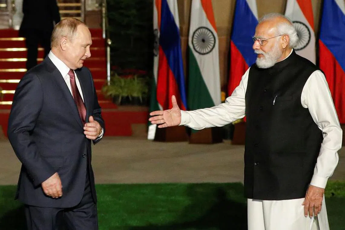 India's Prime Minister Narendra Modi welcomes Russia's President Vladimir Putin ahead of their meeting at Hyderabad House in New Delhi, India, December 6, 2021. REUTERS/Adnan Abidi/File Photo