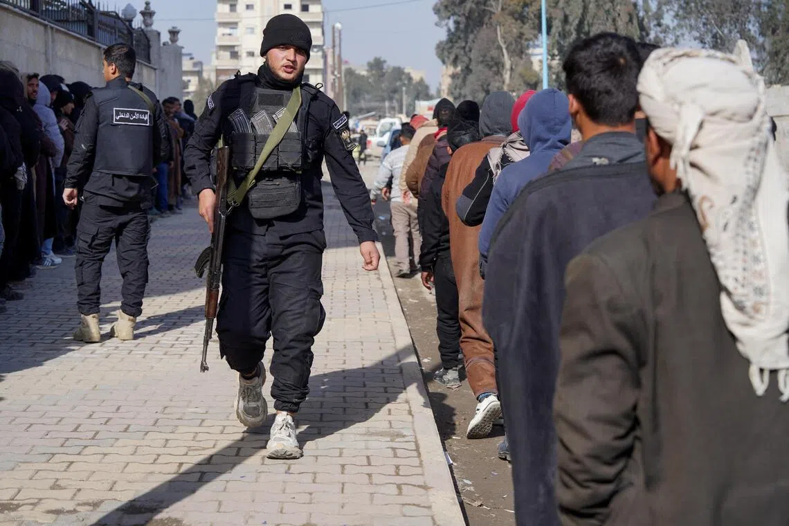Members of the Kurdish-led Syrian Democratic Forces queuing to settle their status with the Syrian government in Raqqa, Syria, on Jan 27.