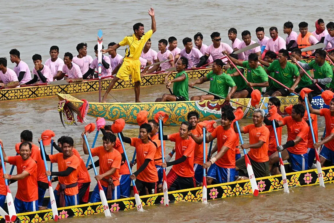 Participants row dragon boats during a competition as part of the Water Festival on the Tonle Sap river in Phnom Penh on Nov 26.