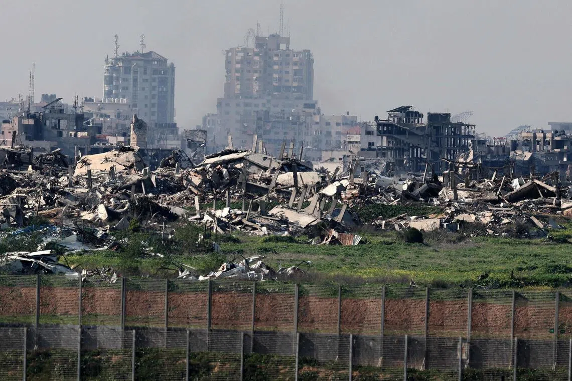 TOPSHOT - This picture taken from a position at Israel's border with the Gaza Strip shows destroyed buildings in the besieged Palestinian territory on February 5, 2026. The October 7, 2023, Hamas attack just across the Israel-Gaza Strip border which resulted in the deaths of 1,221 people on the Israeli side, triggered the Gaza war in which over 71,800 Palestinians have been killed and thousands of buildings destroyed. (Photo by Jack GUEZ / AFP)