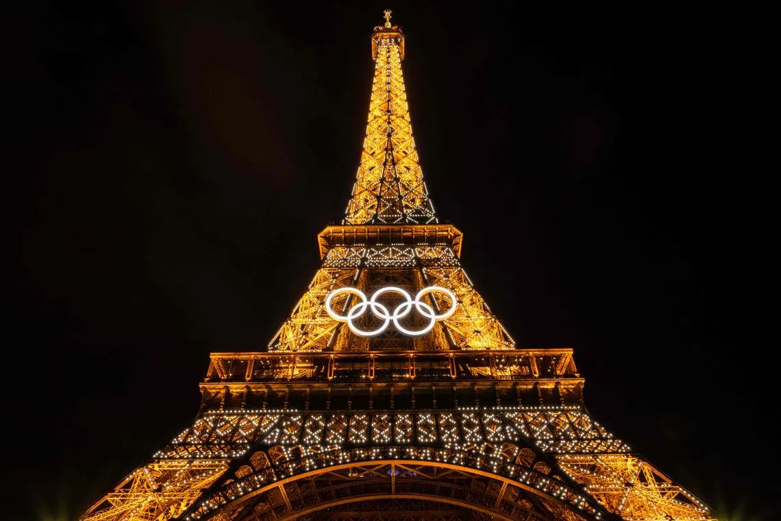 The Olympic Rings on The Eiffel Tower in Paris on June 26, ahead of the forthcoming 2024 Paris Olympic Games. France's economy will get a boost from the Paris Olympics this quarter, with economic growth set to increase by 0.3 percentage points thanks to the sporting extravaganza, state statistics body Insee said on July 9.